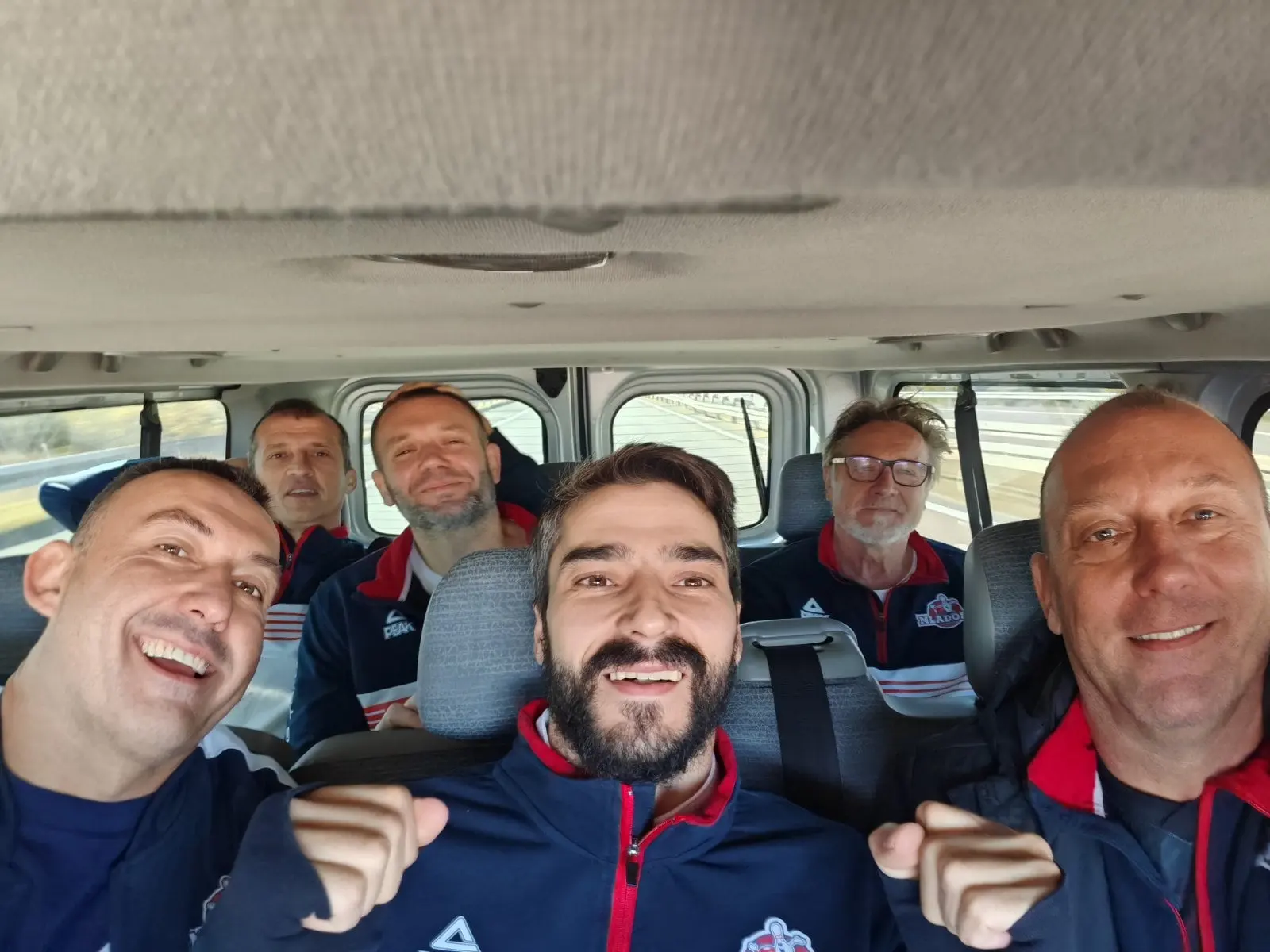 Selfi u kombiju: nasmejani igrači Mladosti u teget trenerkama kluba podižu palčeve.